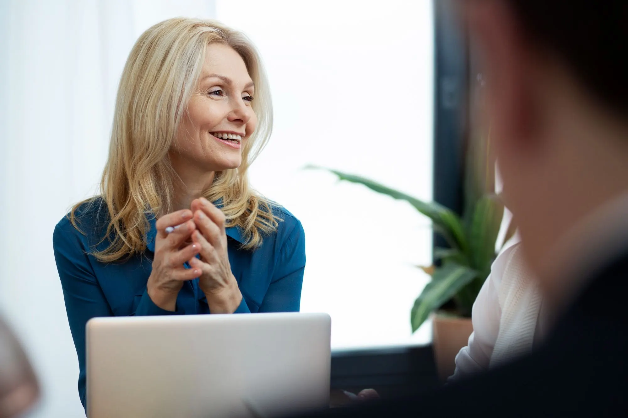 MaxRefund advisor smiling while discussing finances with a client